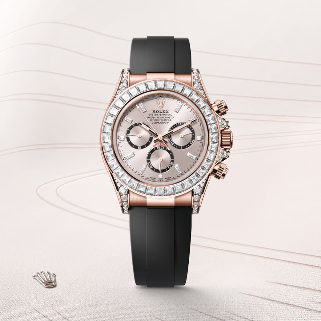 A Rolex watch with a diamond bezel, rose gold case, and black strap displayed on a light background.