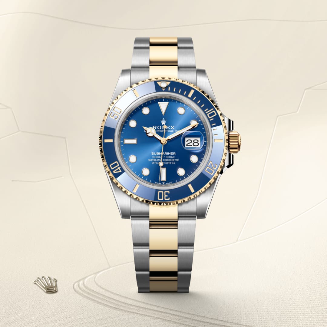 A Rolex Submariner watch with a blue dial and two-tone silver and gold bracelet on a light background.