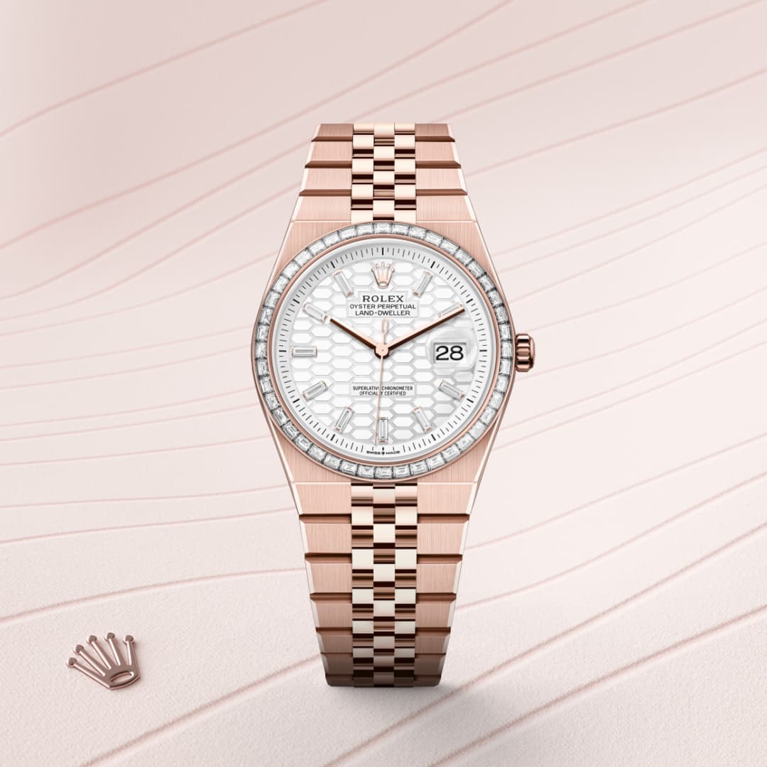 A rose gold Rolex watch with a white patterned dial and date display, on a light, wavy background.
