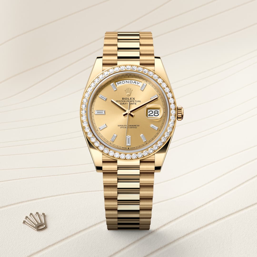 Gold Rolex watch with diamond bezel, day and date display, on a textured beige background.