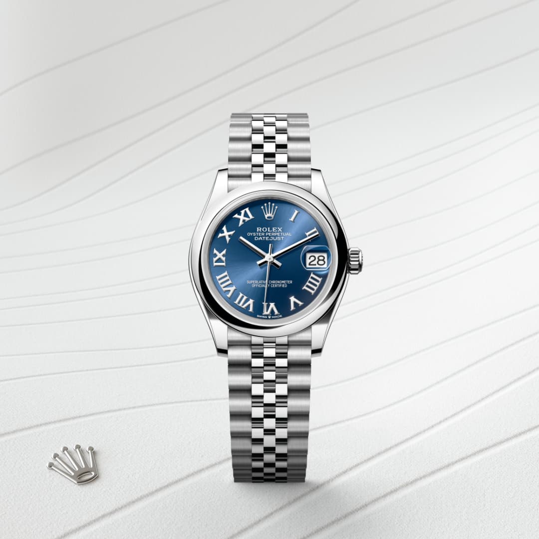 A silver Rolex watch with a blue dial and Roman numerals, displayed on a textured white background.