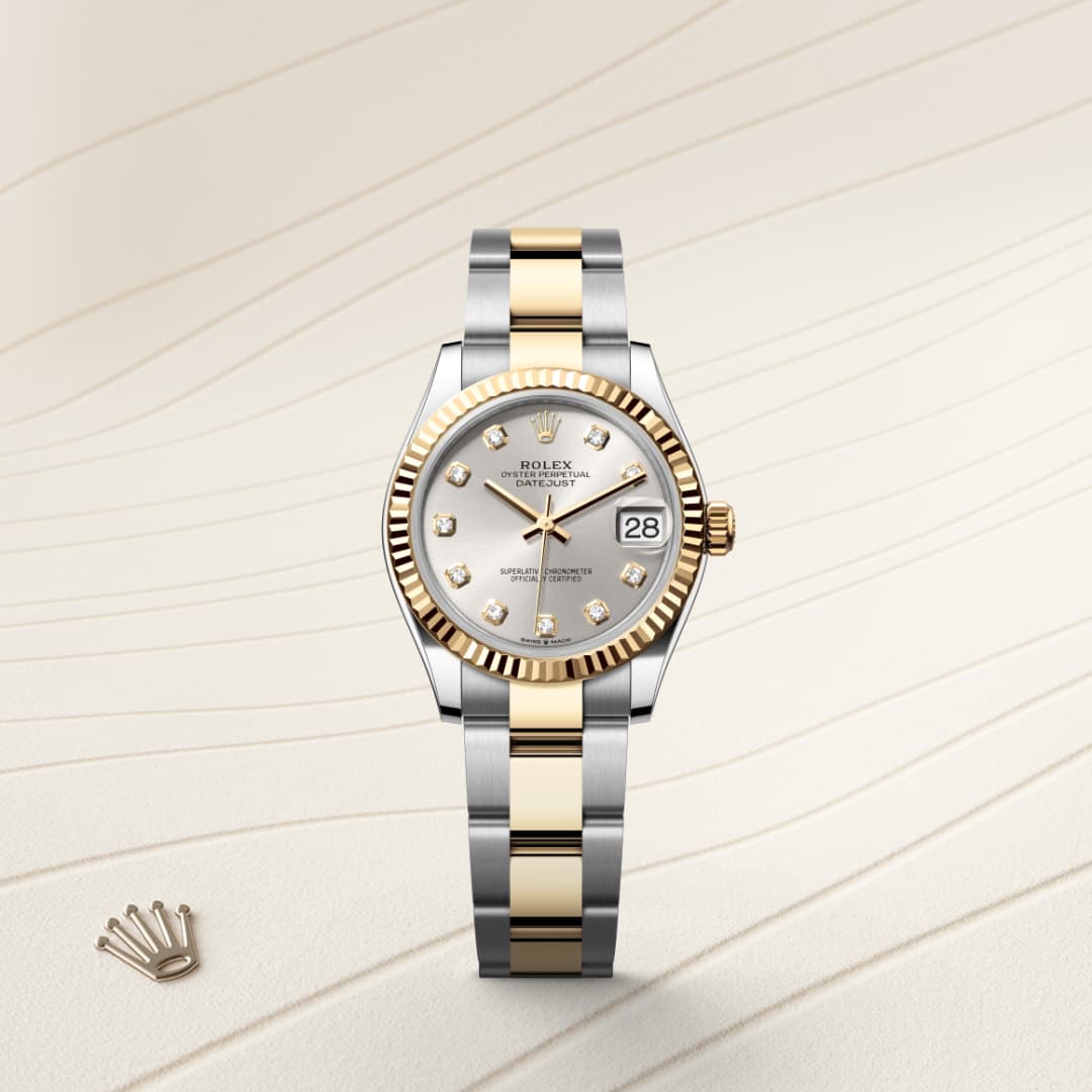 A two-tone Rolex watch with a silver and gold band, diamond markers, and date display on a textured background.