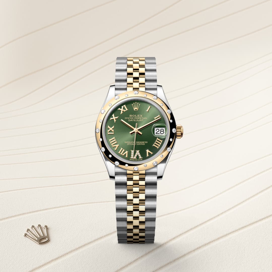 Two-tone Rolex watch with a green dial and Roman numerals on a beige textured background.