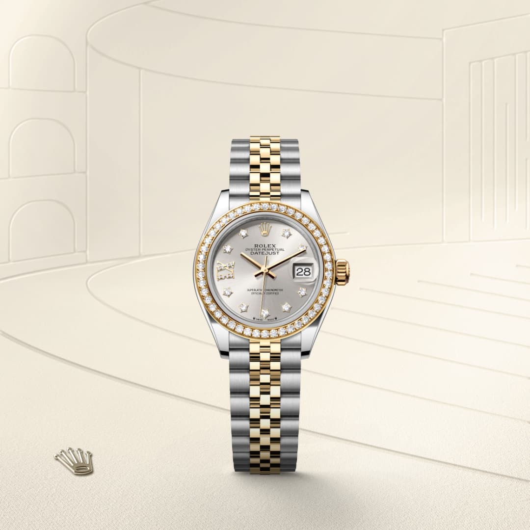 A two-tone Rolex watch with a diamond bezel and bracelet, displayed against a light, elegant background.