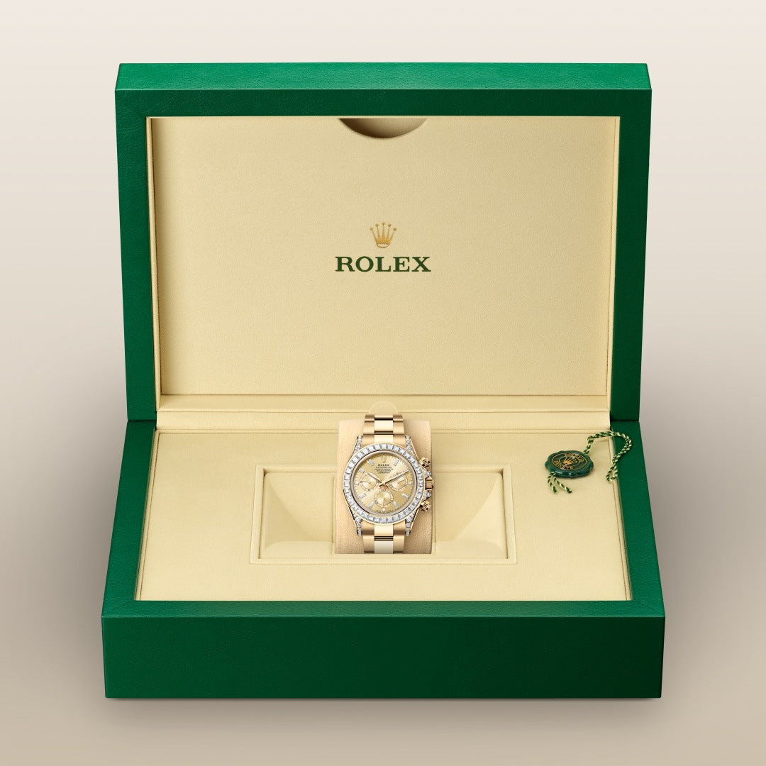 A gold Rolex watch with diamond accents displayed in an open green and cream Rolex box.