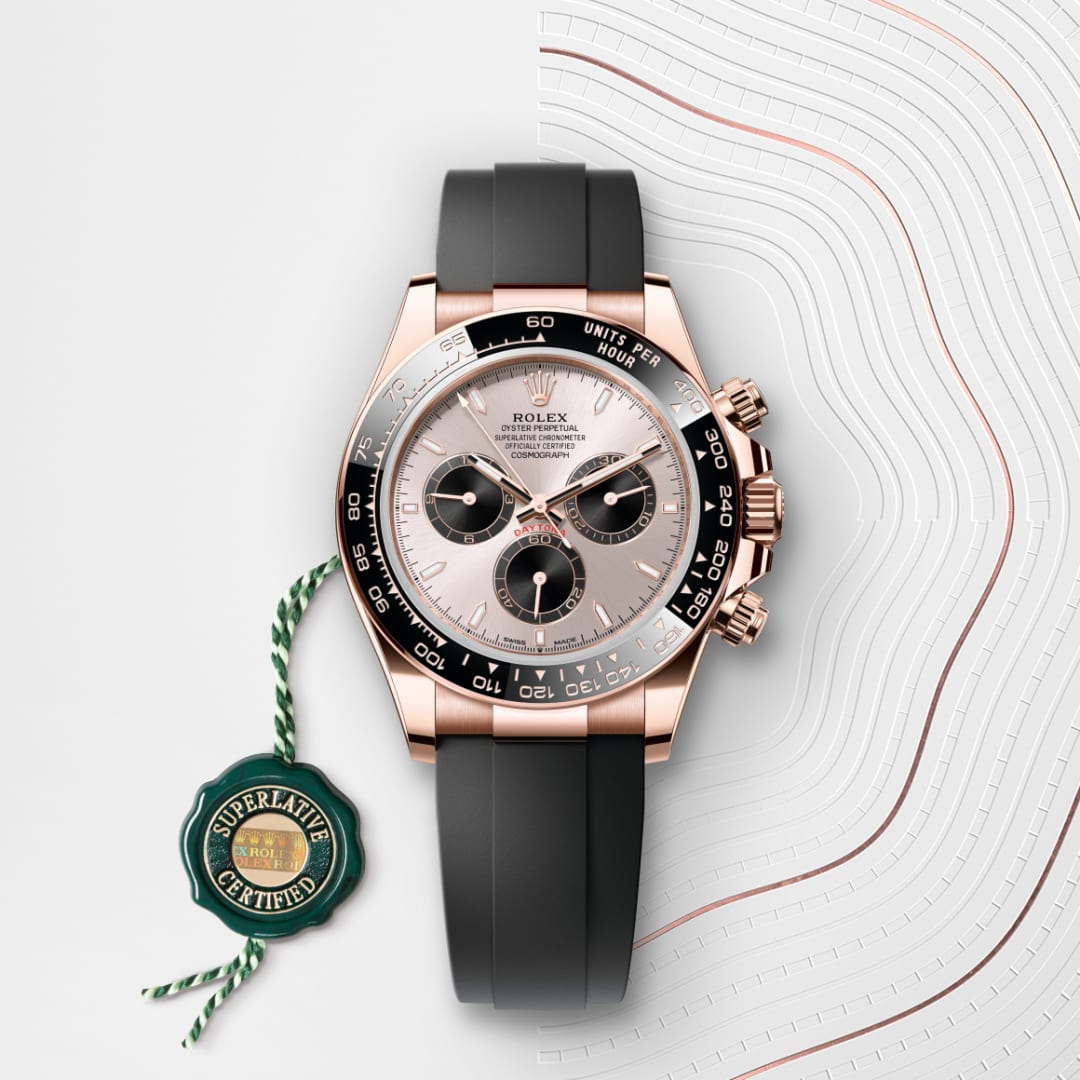 A Rolex Cosmograph Daytona watch with a black strap and gold accents, shown with a green Superlative Certified tag.