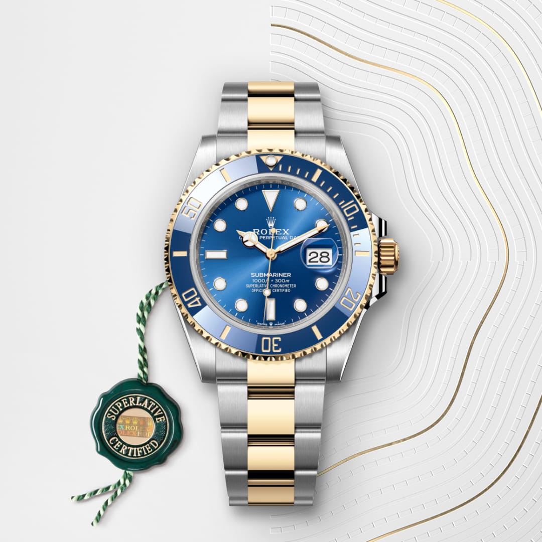 A Rolex Submariner watch with a blue dial and gold accents, displayed with a green Superlative Certified tag.