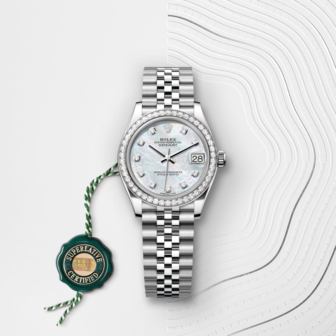 A silver Rolex watch with a diamond bezel and bracelet, featuring a date display and certification tag.
