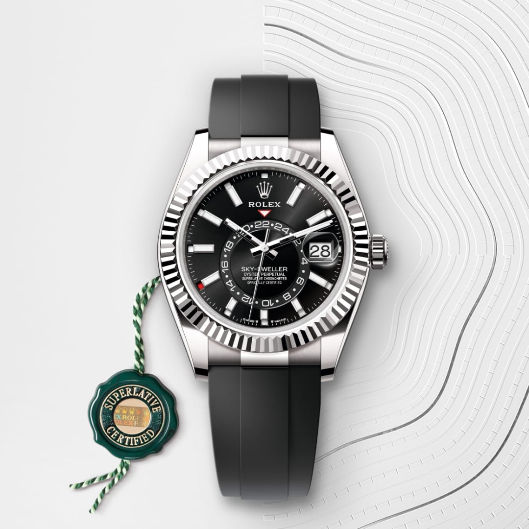 Rolex Sky-Dweller watch with black dial and rubber strap, next to a green Superlative Certified tag.