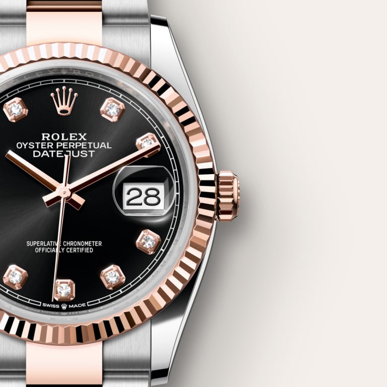 Close-up of a Rolex Datejust watch with a black dial, diamond hour markers, and date display at 3 o’clock.