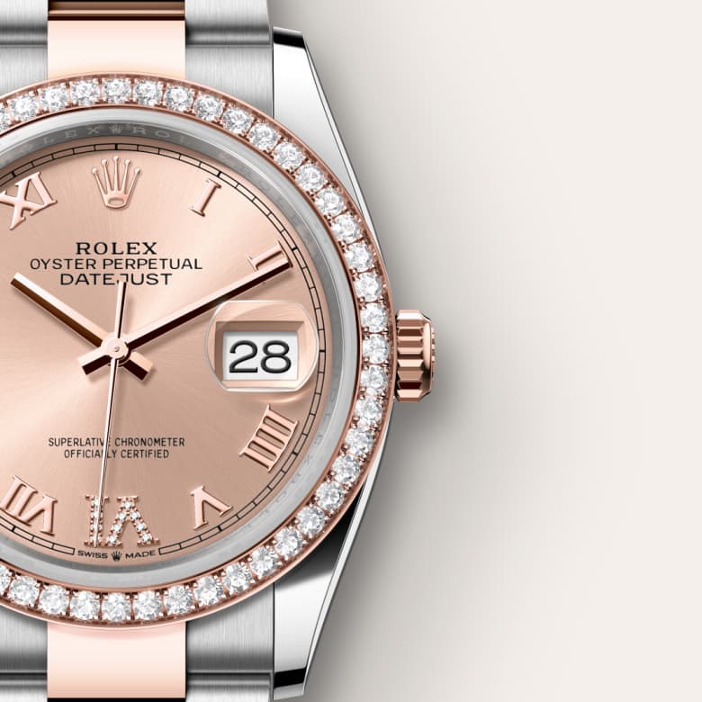Close-up of a Rolex Datejust watch with a rose gold face, diamond bezel, and Roman numeral markers.