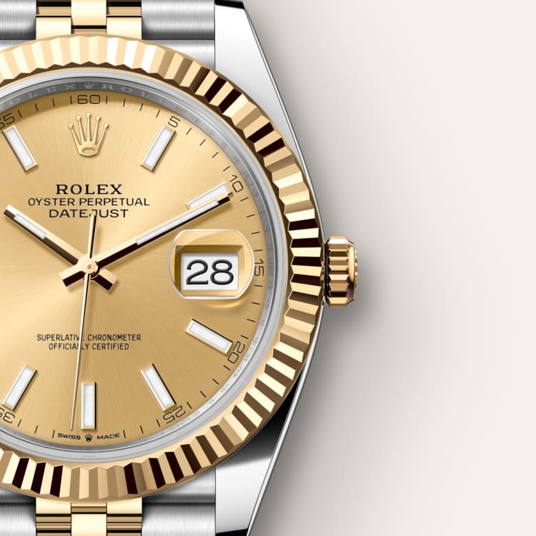 Close-up of a Rolex Datejust watch with a gold dial, date display, and two-tone bezel and bracelet.