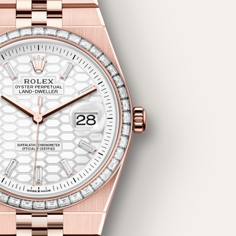 Close-up of a Rolex watch with a honeycomb-patterned white dial, diamond-set bezel, and date display at 3 o’clock.