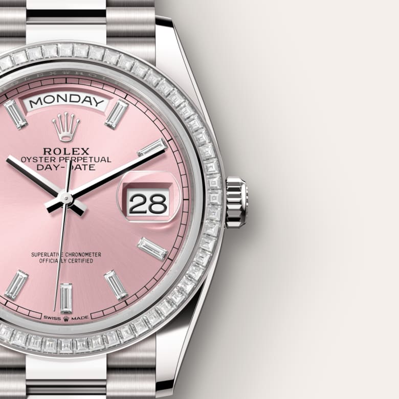 Close-up of a Rolex watch with a pink dial, diamond bezel, and date and day display.