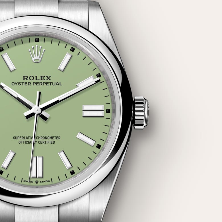Close-up of a Rolex Oyster Perpetual watch with a green dial and silver stainless steel case and band.