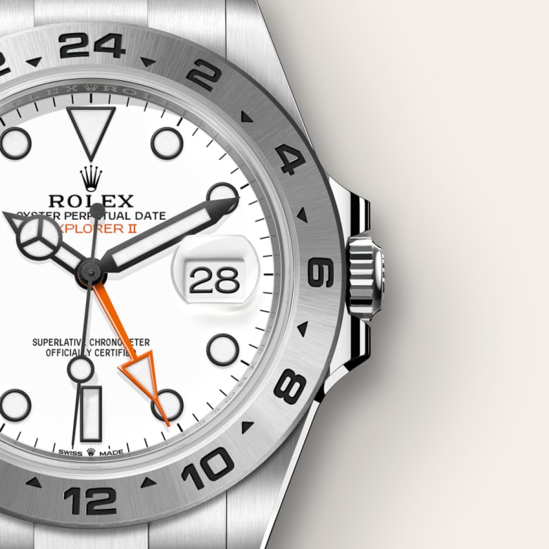 Close-up of a Rolex Explorer II watch with a white dial and orange 24-hour hand.