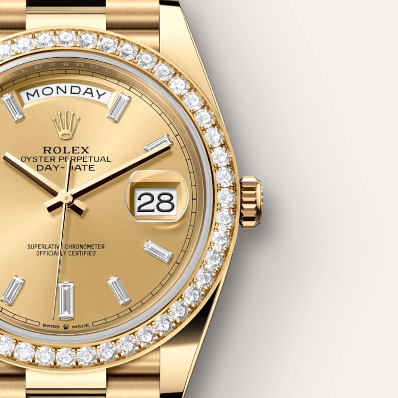 Gold Rolex Day-Date watch with diamond bezel and markers, showing Monday and the date 28 on the dial.