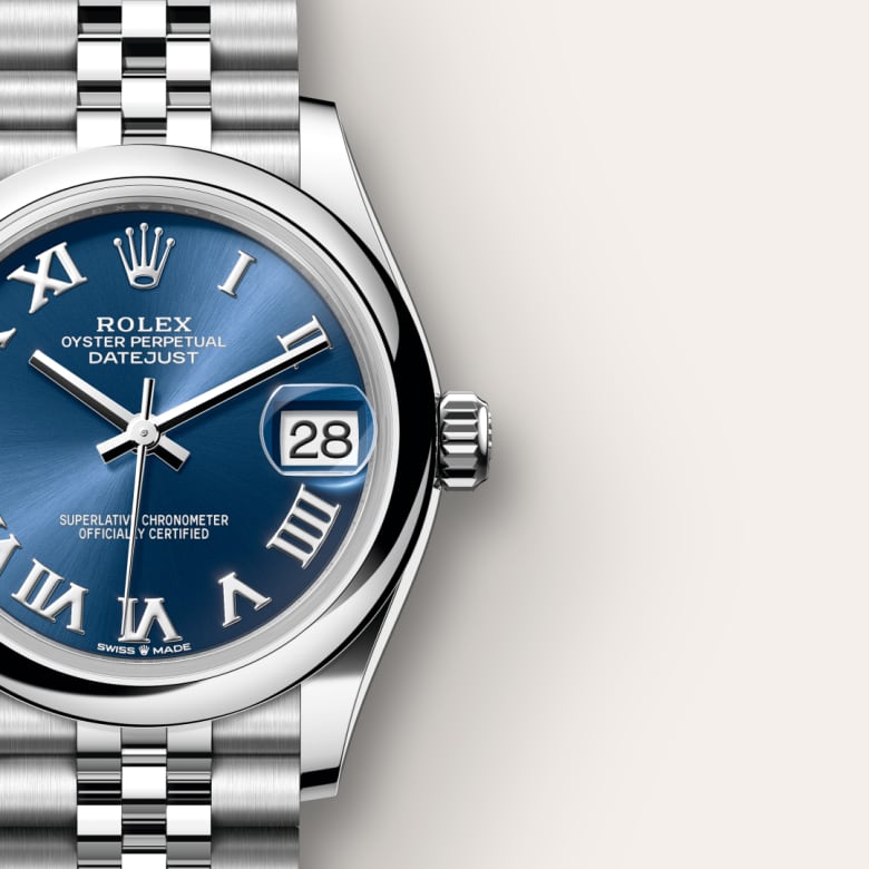 Close-up of a Rolex Datejust watch with a blue dial, Roman numerals, and a stainless steel bracelet.