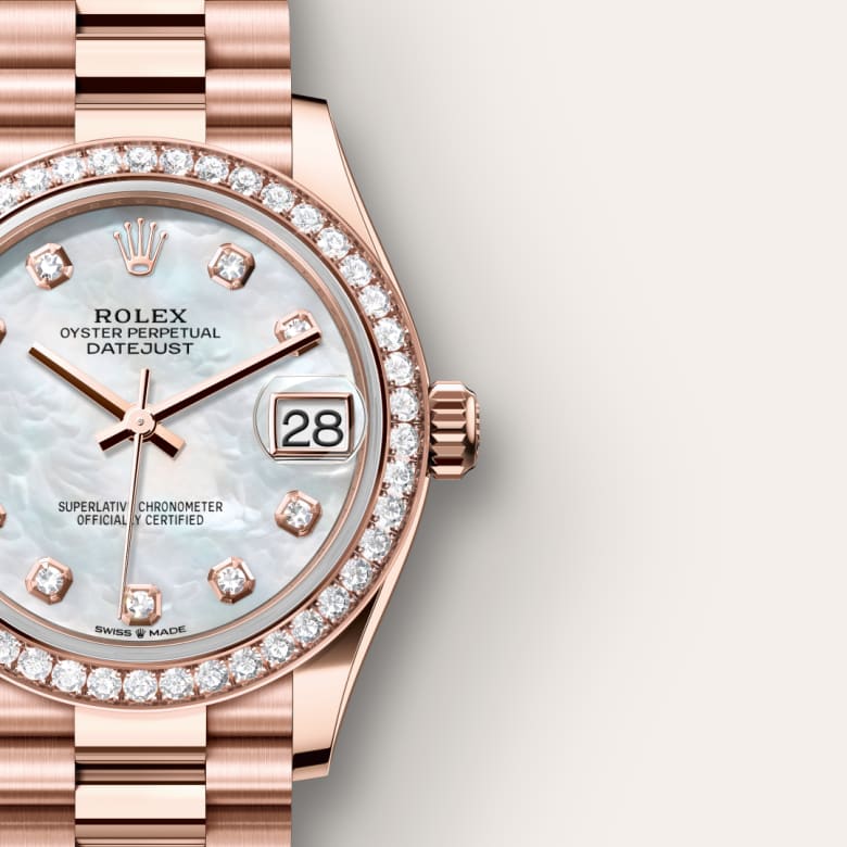 A rose gold Rolex Datejust watch with a diamond bezel and mother-of-pearl dial displaying the date.