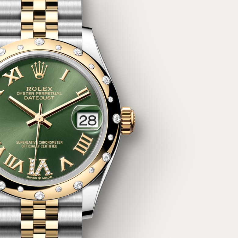 A gold and silver Rolex Datejust watch with a green dial, diamond markers, and a date window showing the 28th.