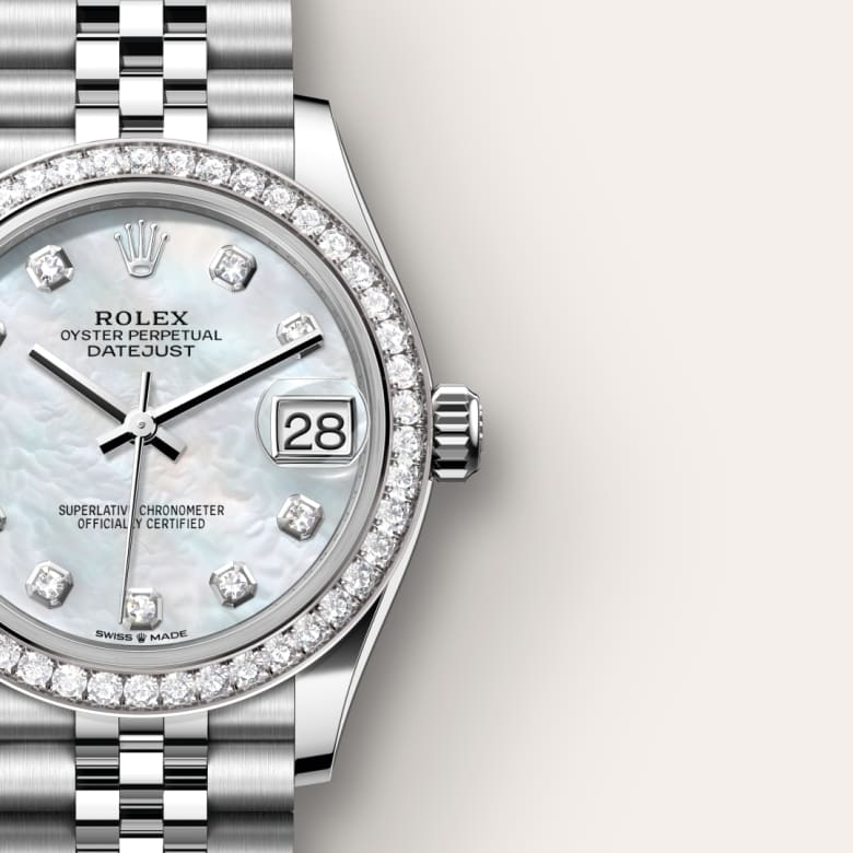 Close-up of a Rolex Datejust watch with a diamond bezel and mother-of-pearl dial showing the date.