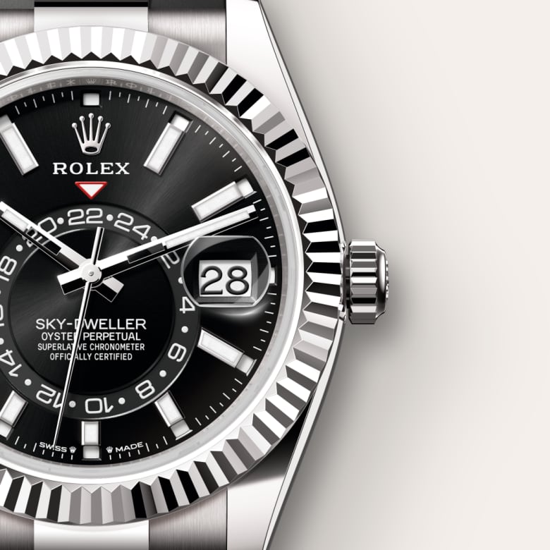 Close-up of a Rolex Sky-Dweller watch with a black dial and date displayed at 3 o’clock.