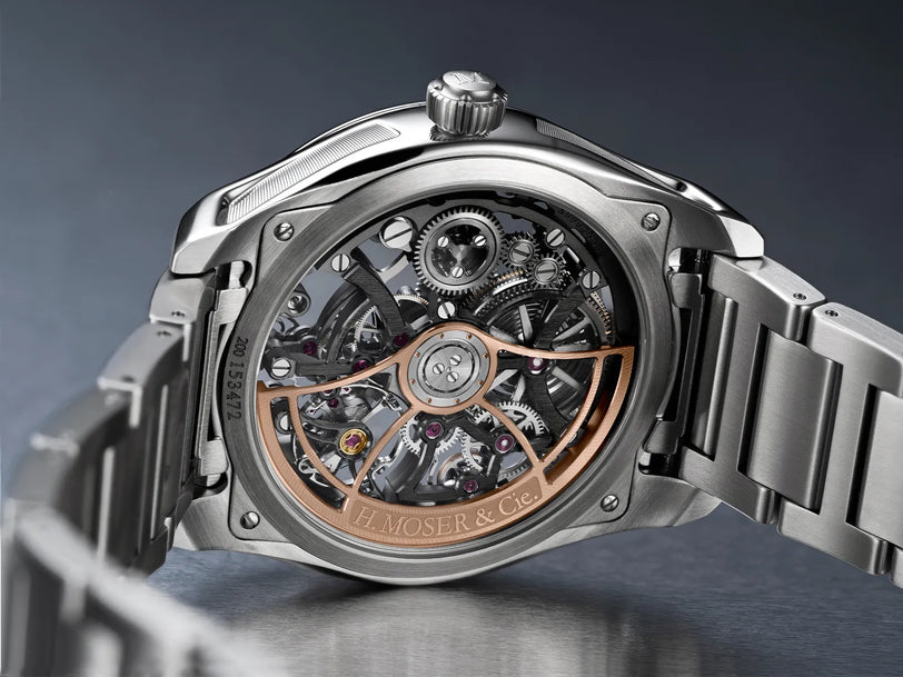 Stainless steel skeleton watch with exposed mechanical movement, rose gold accents, and visible gears on dial.