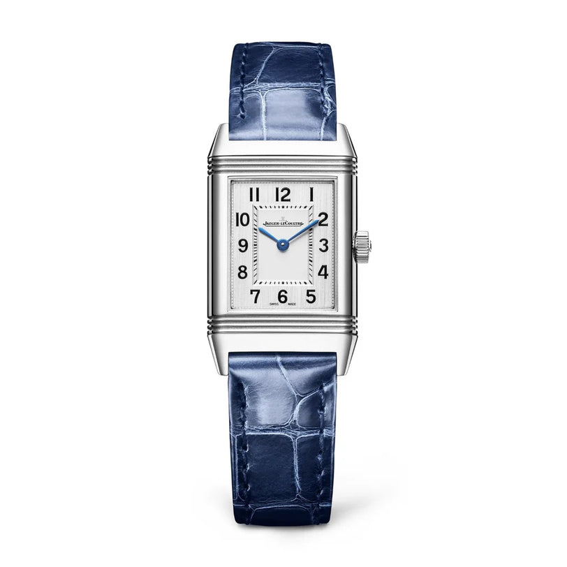 The Jaeger-LeCoultre Reverso Classic Monoface is a rectangular stainless steel watch with a white dial, blue hands, black Arabic numerals, a textured blue leather strap, and precise quartz movement.