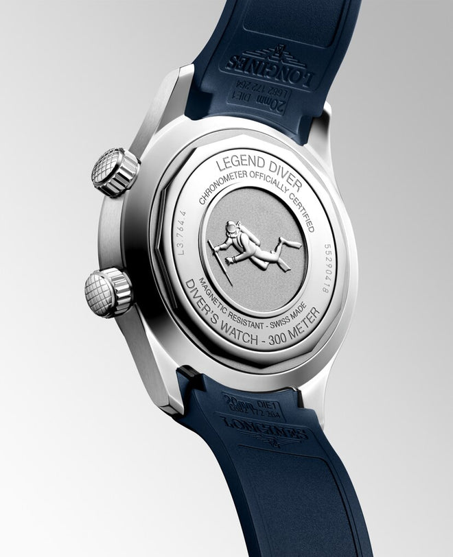 The back of the Longines Legend Diver watch features an engraving of a diver and watch details, paired with a blue strap.