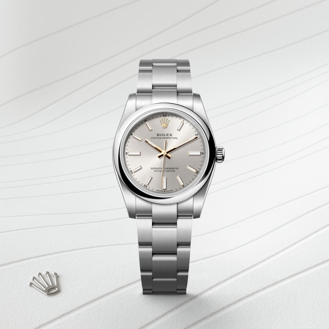 A silver Rolex Oyster Perpetual watch with a light gray dial on a textured white surface.