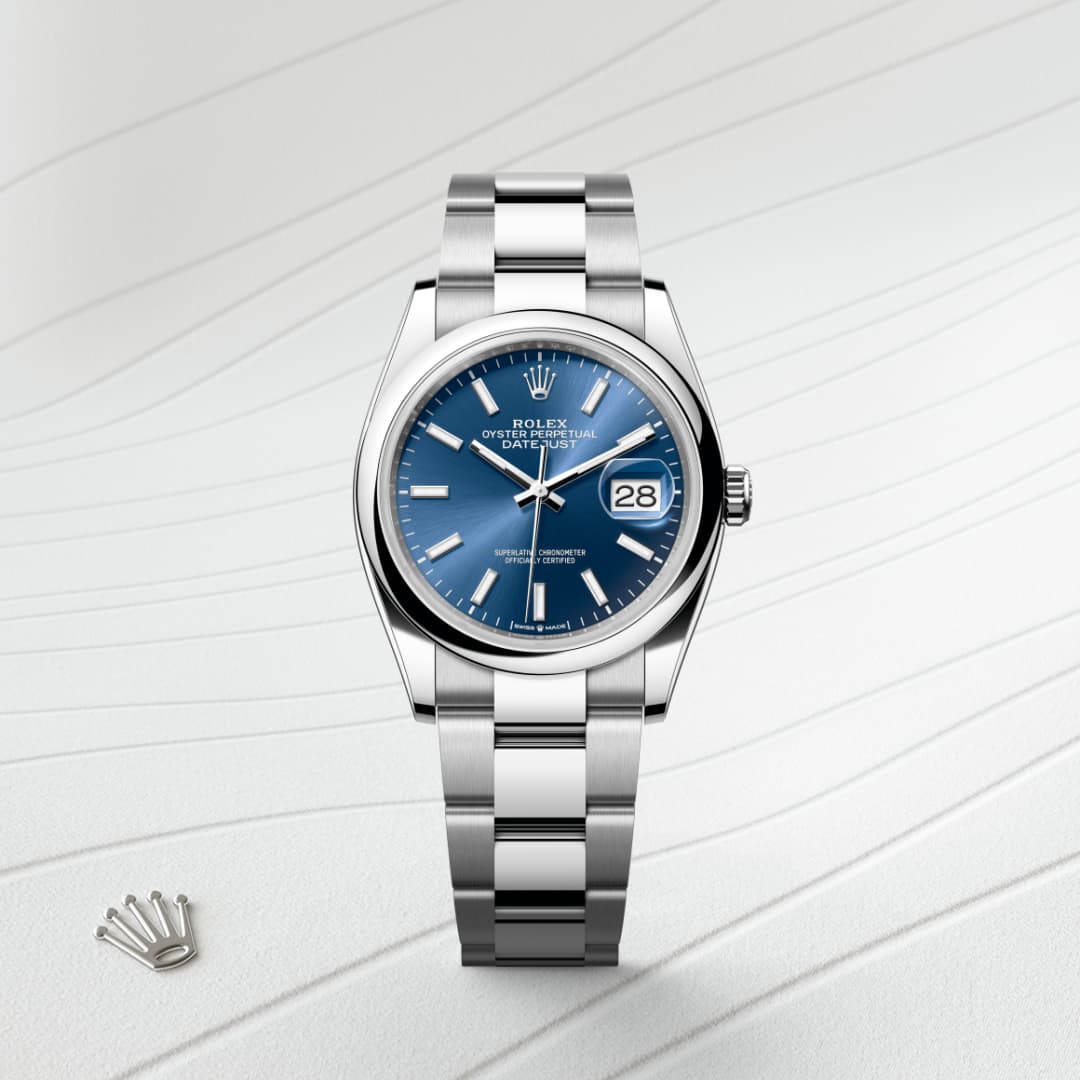 Silver Rolex watch with a blue face, date display, and metal band on a textured white background.