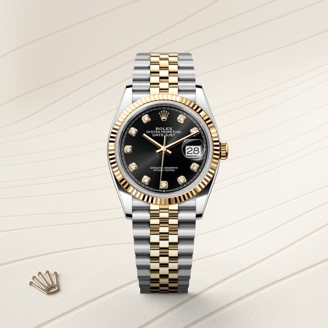 A two-tone Rolex watch with a black dial, gold accents, and diamond hour markers on a striped background.