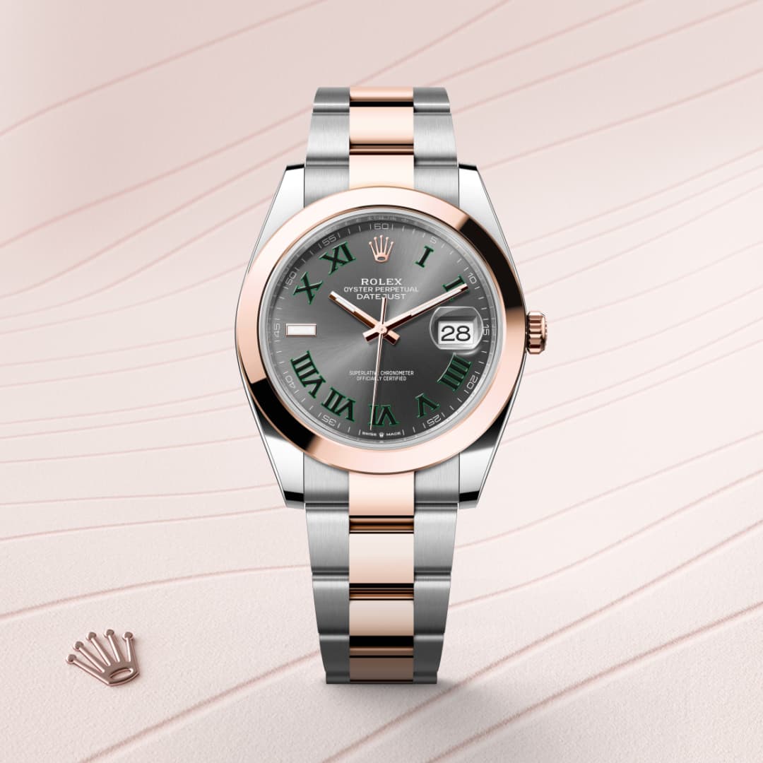 A Rolex Datejust watch with a silver and rose gold band, green Roman numerals, and a date display.
