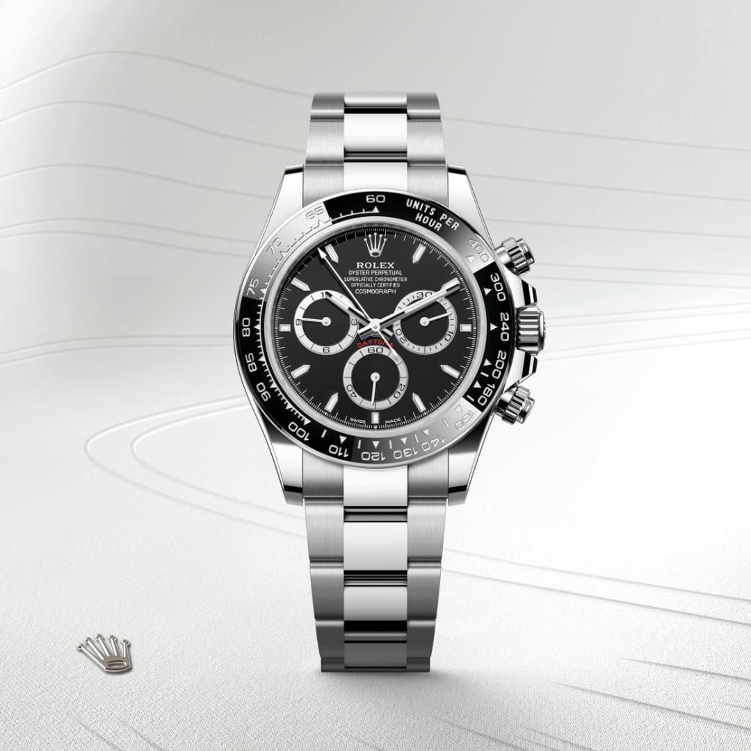 A stainless steel Rolex Daytona watch with a black dial, three sub-dials, and a silver bracelet.
