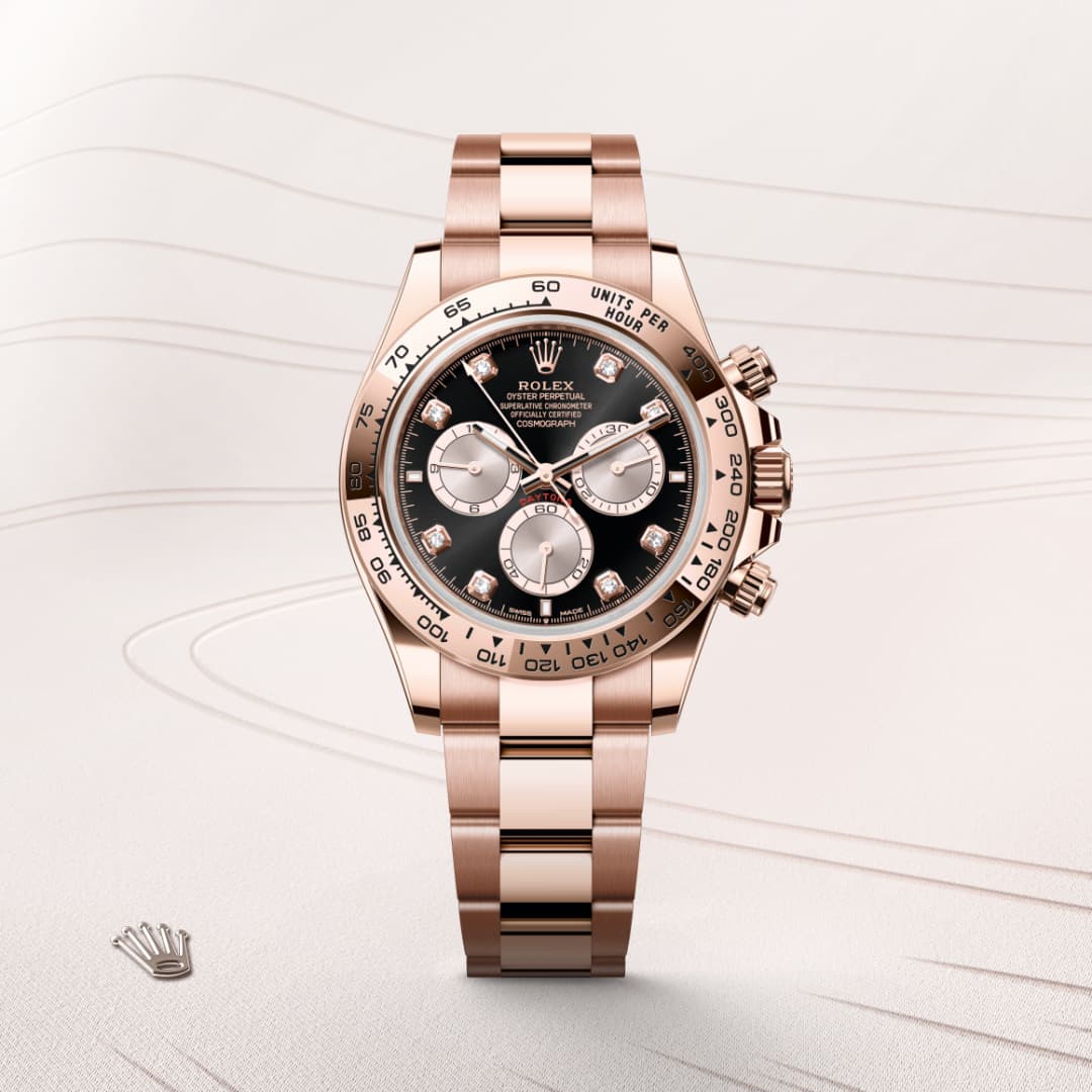 A rose gold Rolex wristwatch with a black dial and three subdials, displayed on a light background.