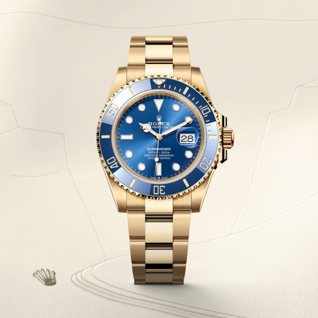 A gold Rolex Submariner watch with a blue dial and bezel, displayed on a light beige background.