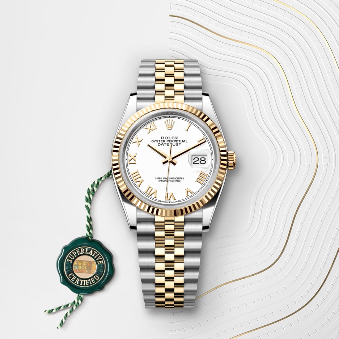 A two-tone Rolex Datejust watch with a white dial and Roman numerals, displayed on a white patterned surface.