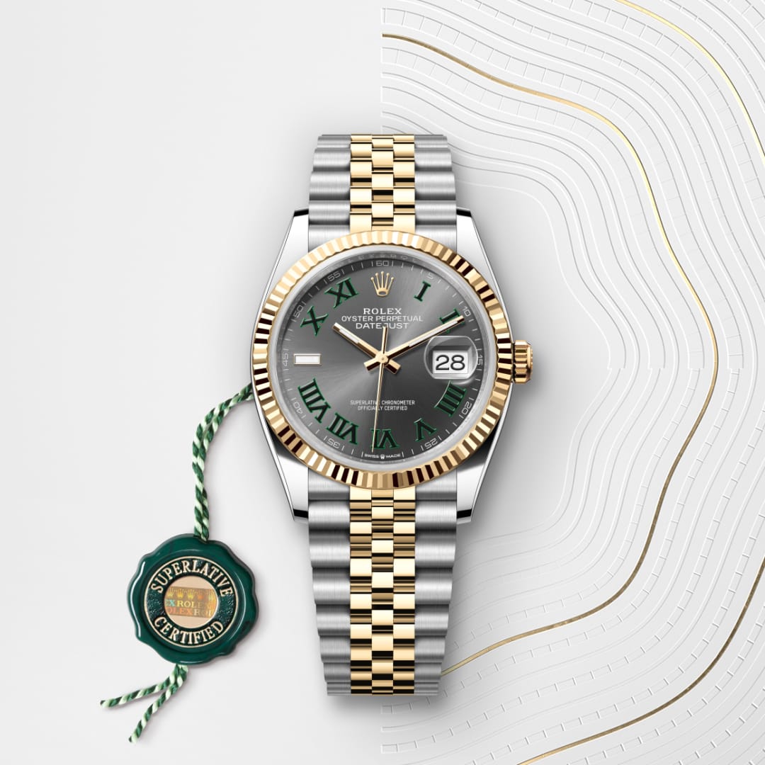A two-tone Rolex Datejust watch with a green dial, Roman numerals, and a Superlative Certified tag.