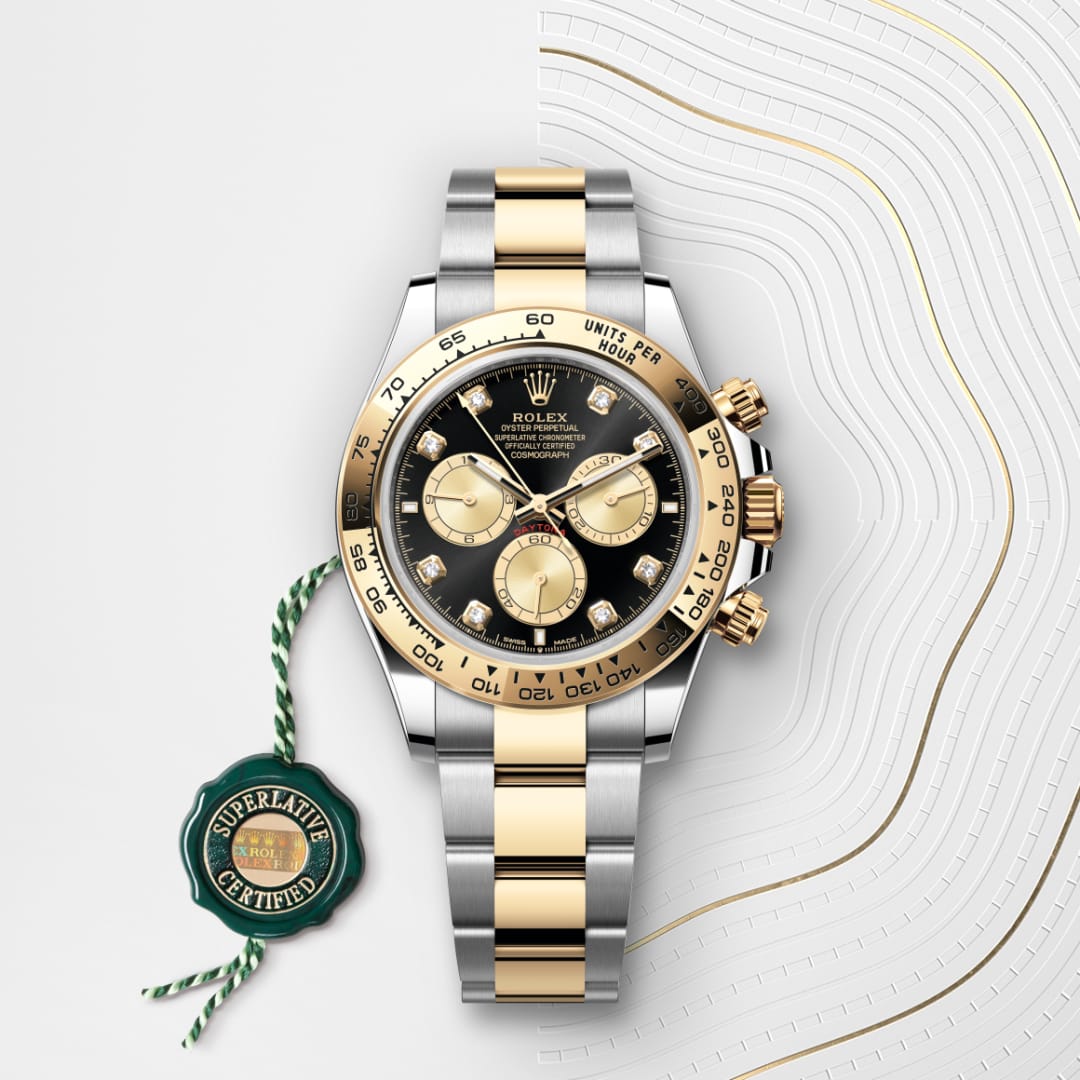 A Rolex Daytona watch with a gold and silver band, black dial, and three subdials, shown with a green certification tag.