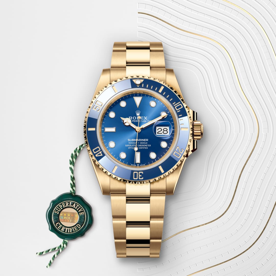 Gold Rolex Submariner watch with blue dial and bezel, shown with a green Superlative Certified tag.