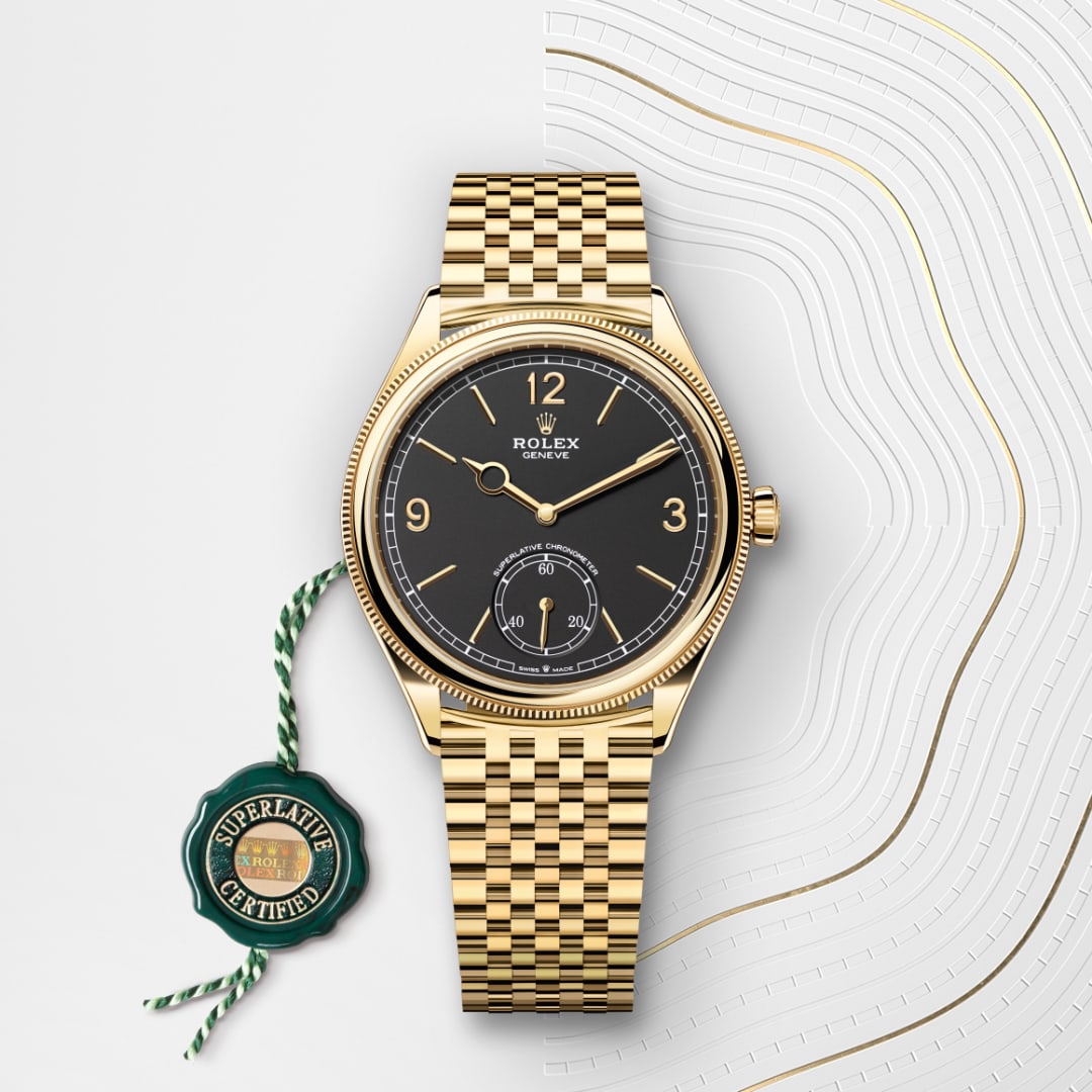 Gold Rolex wristwatch with a black dial and Superlative Certified tag on a white and gold patterned background.