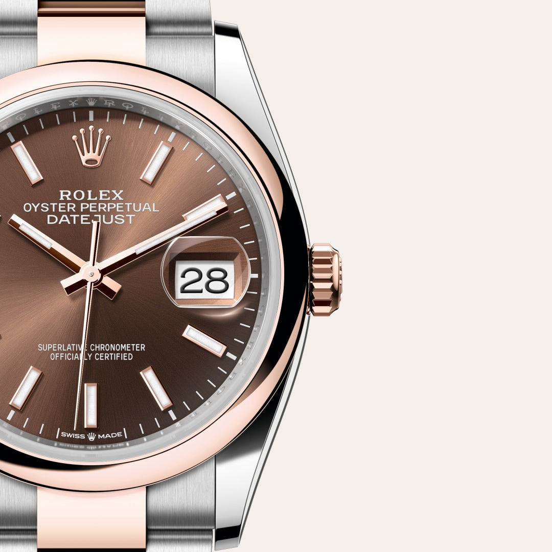 Close-up of a Rolex Datejust watch with a brown dial, date window, and two-tone metal case and bracelet.