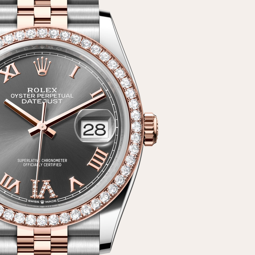 Close-up of a Rolex Datejust watch with a gray dial, diamond bezel, and rose gold Roman numerals.