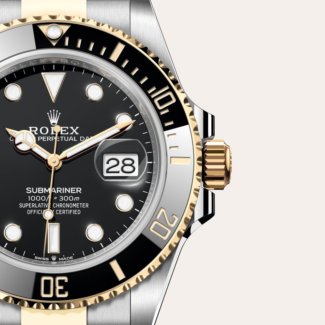 Close-up of a Rolex Submariner watch with a black dial, gold accents, and date display showing the 28th.