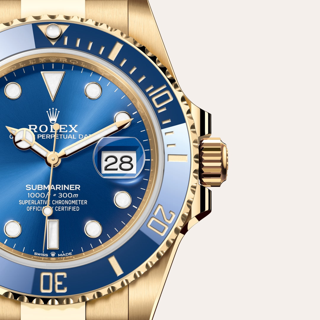 Close-up of a gold Rolex Submariner watch with a blue dial and bezel, showing the date as 28.