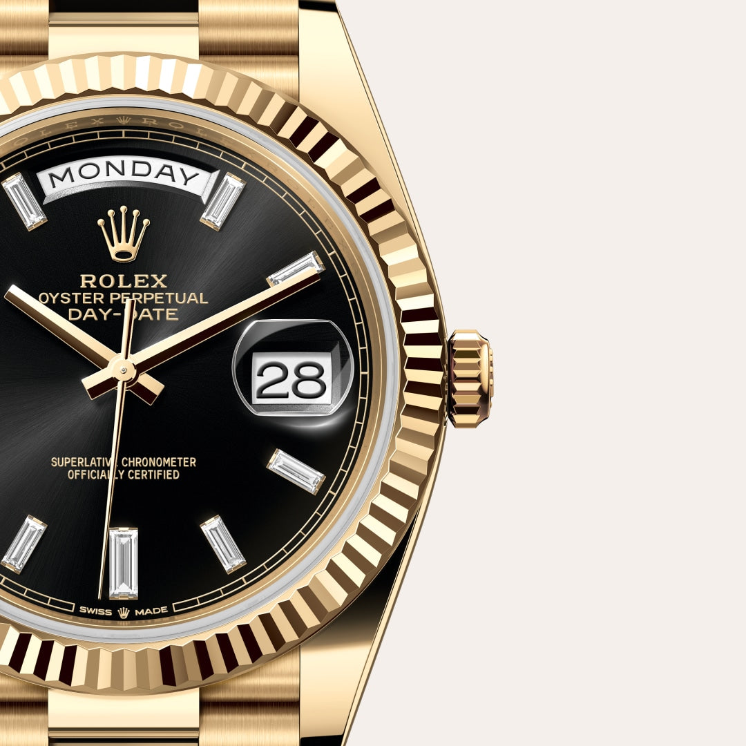 Close-up of a gold Rolex Oyster Perpetual Day-Date watch with a black dial and diamond hour markers.