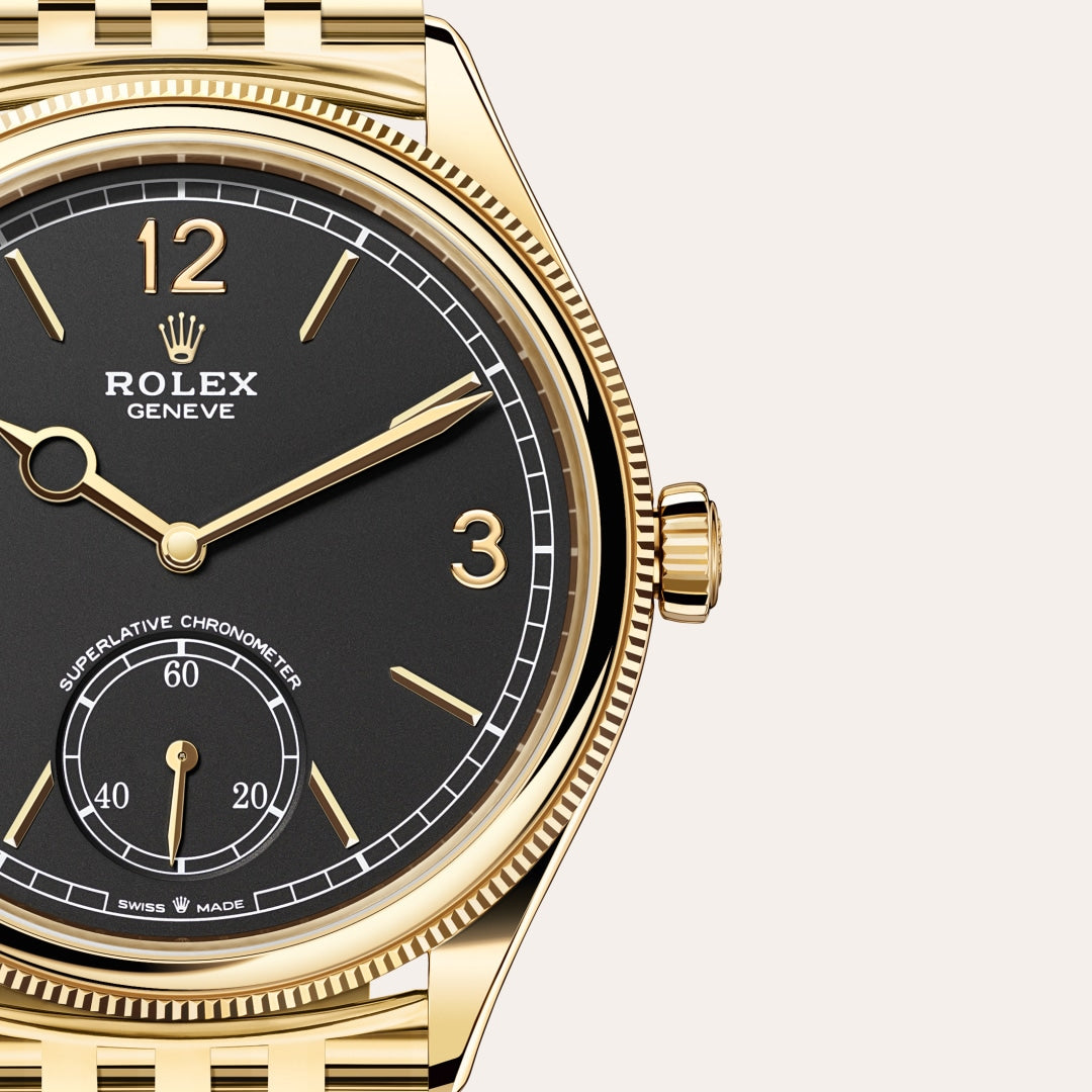Gold Rolex watch with a black face, gold hour markers, and a small seconds subdial at 6 oclock.