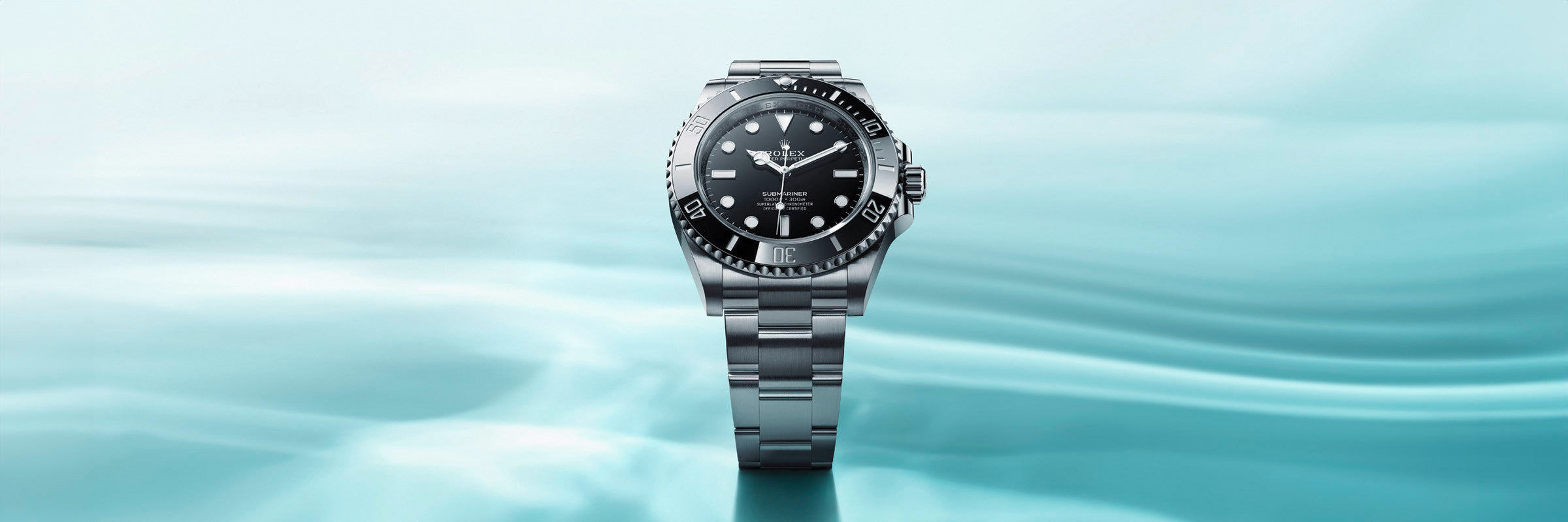 Rolex Submariner over a wide blue water-like background