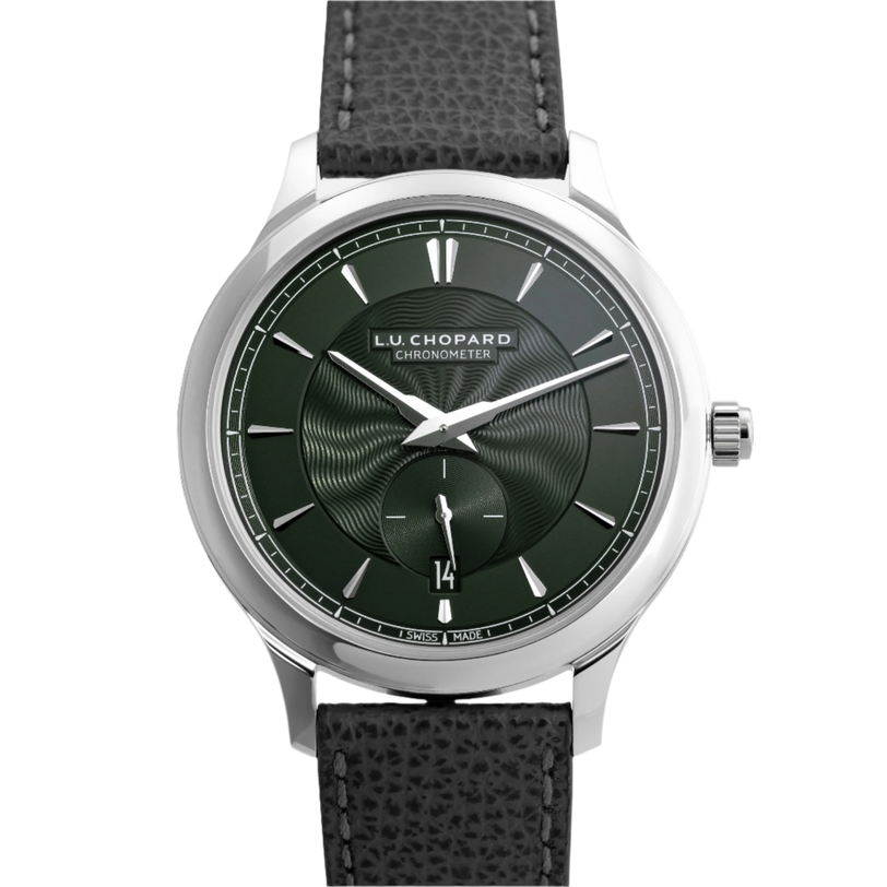 The Chopard L.U.C XPS 1860 Officer Limited Edition for Hodinkee features a white gold case, textured black guilloché dial, silver markers and hands, date at 6 oclock, and a black leather strap, displayed on a patterned background.