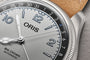 Oris Big Crown Automatic watch with silver dial, blue numerals, date window, and stainless steel case with cork strap detail.